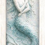 Print of a mermaid with flowing hair and tail in seafoam and white, shown in a light wood-tone frame.