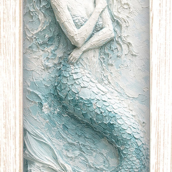 Print of a mermaid with flowing hair and tail in seafoam and white, shown in a light wood-tone frame.