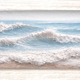 Print of rows of white waves rolling across a pale blue sea, shown in a light wood-tone frame.